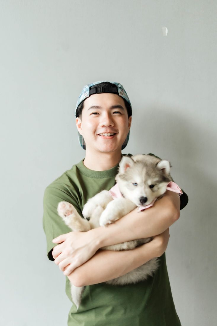 Guest hugging a husky puppy