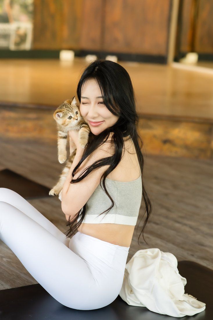 Guest cuddling a tabby kitten