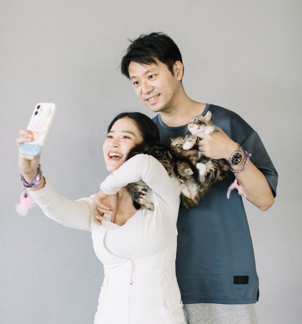 Couple taking a selfie with kittens
