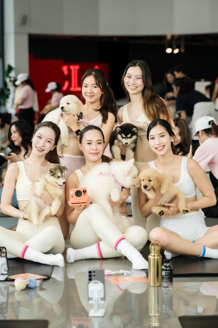 Guests with puppies and a polaroid camera at the Mercedes-Benz Thonburi Phanich event