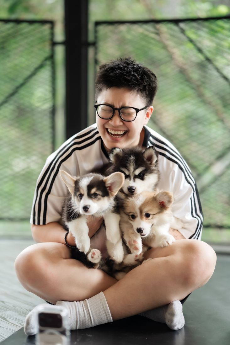 Laughing guest with three puppies