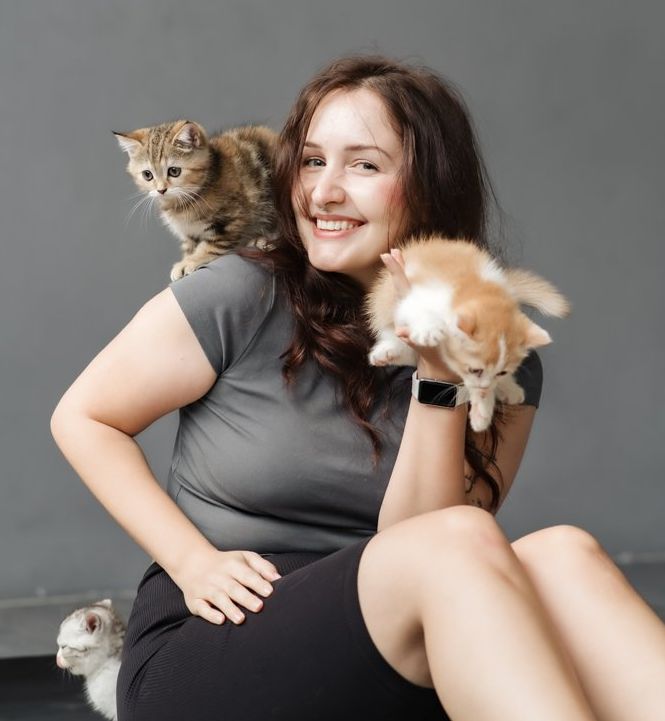 Guest with kittens on her shoulder and hand