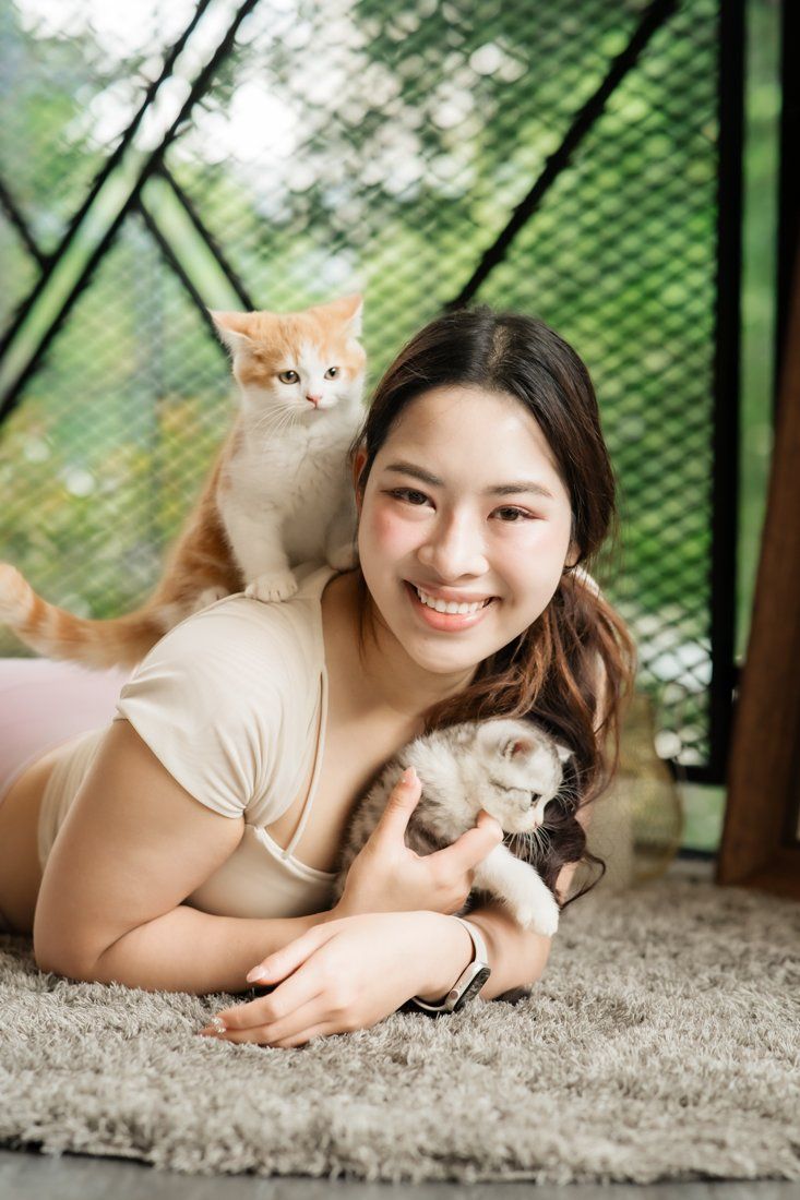 Smiling guest with kittens on the rug