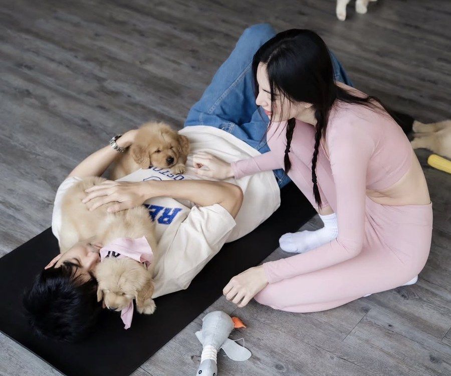 Ter Chantavit relaxing with golden retriever puppies at Furapy
