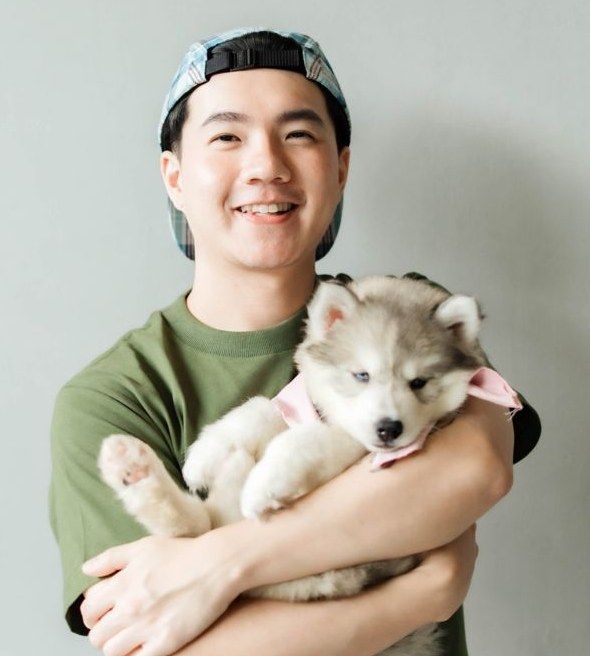 Guest hugging a husky puppy